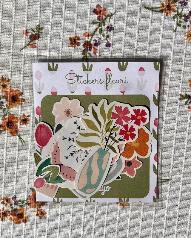 Pack de 12 stickers fleuris Iventyo posé sur une nappe à fleurs